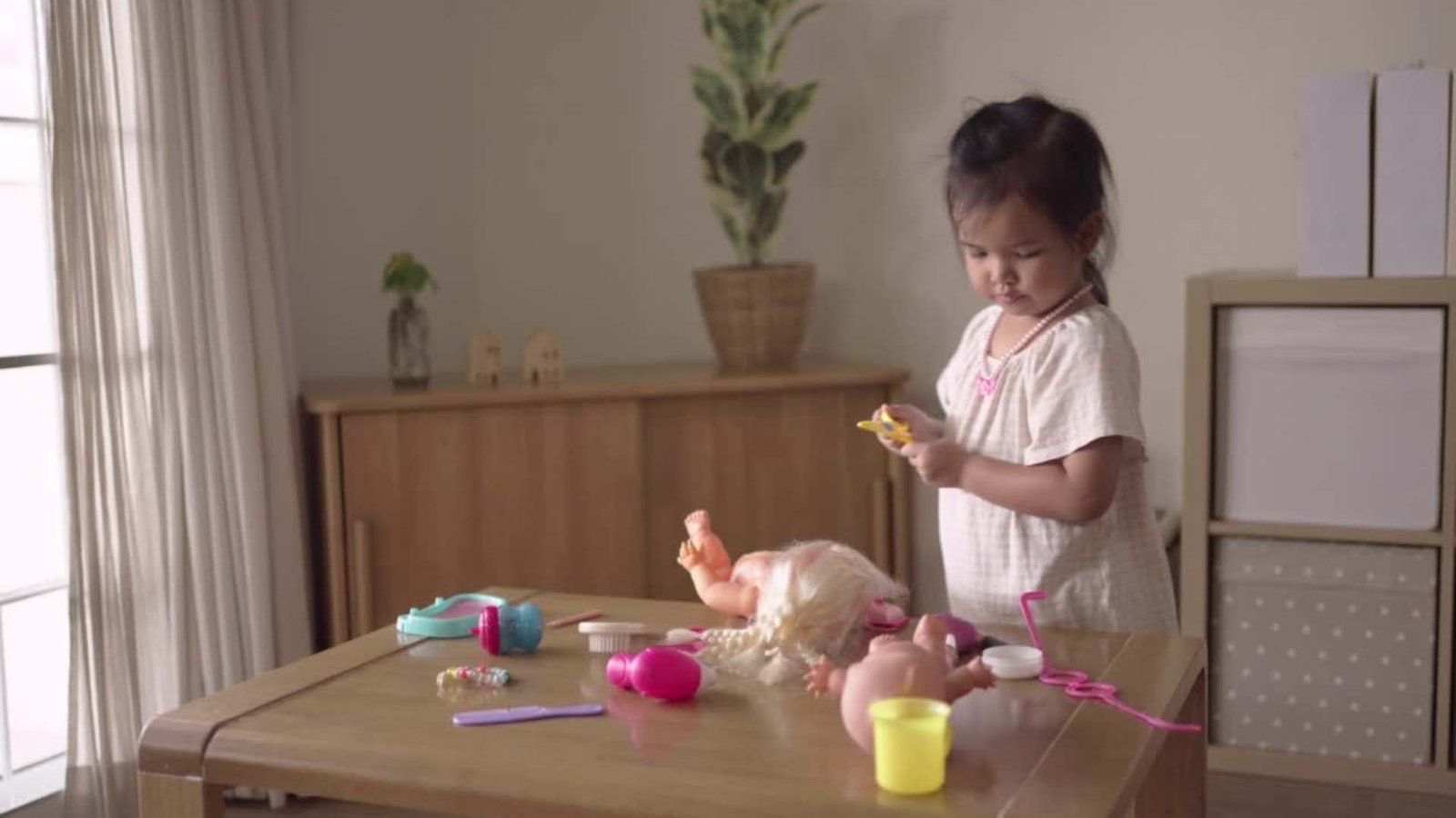 baby playing with baby doll